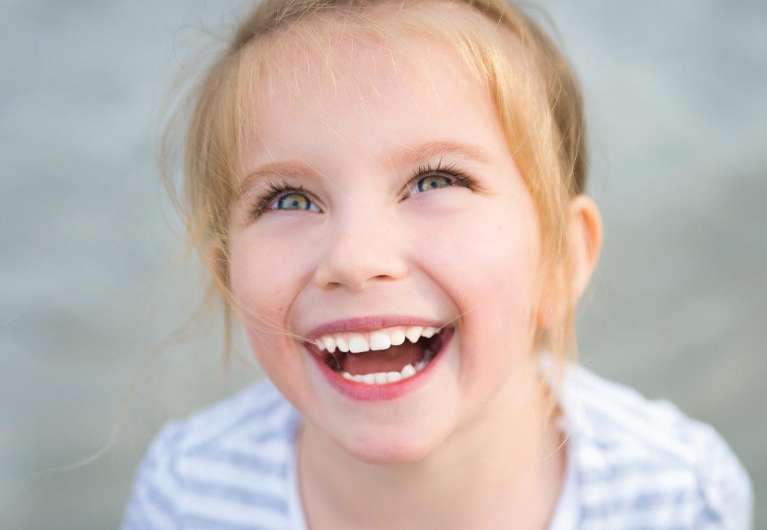 A laughing girl looking up