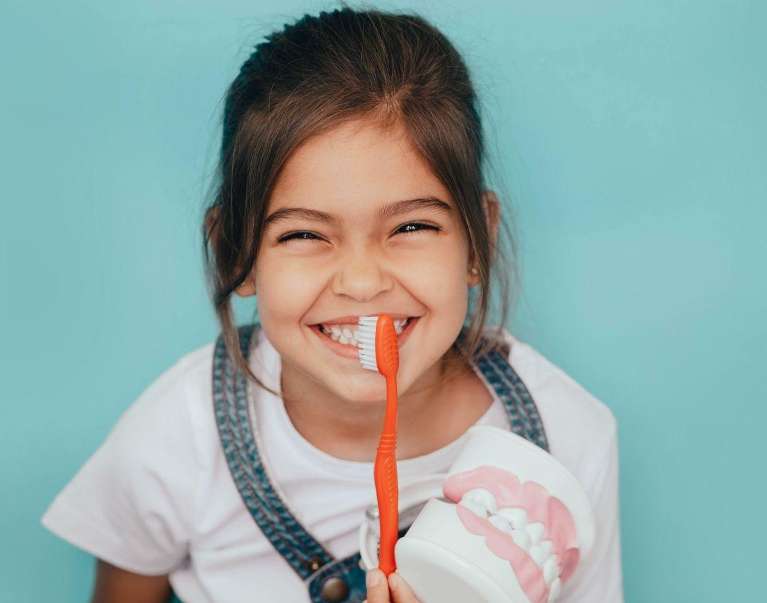 Girl with toothbrush | Scottsdale Pediatric Dentist